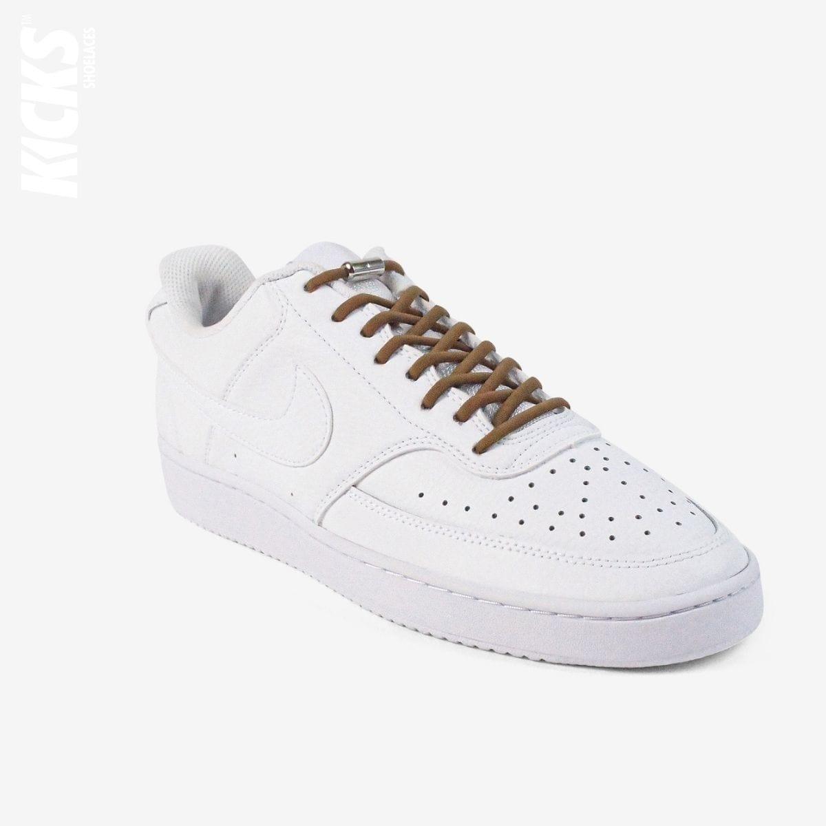Brown oval no-tie elastic shoelaces installed on white sneakers by Kicks Shoelaces