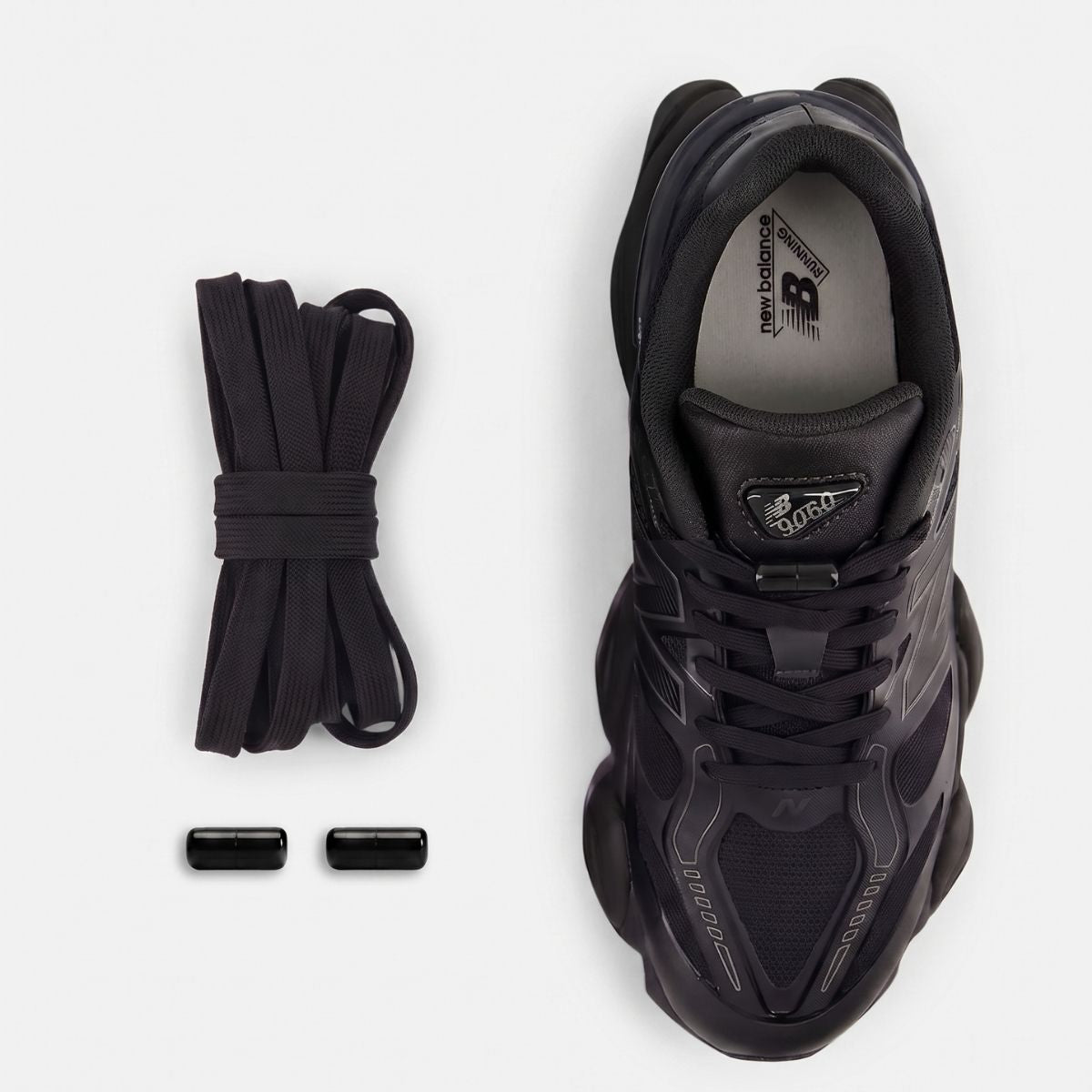 Black elastic no-tie shoelaces with a black capsule lock system installed on a New Balance 9060 sneaker.