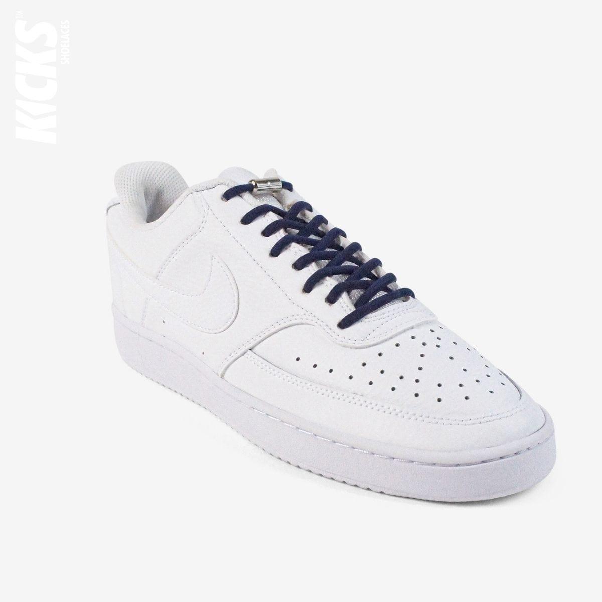 Dark blue oval no-tie elastic shoelaces installed on white sneakers by Kicks Shoelaces