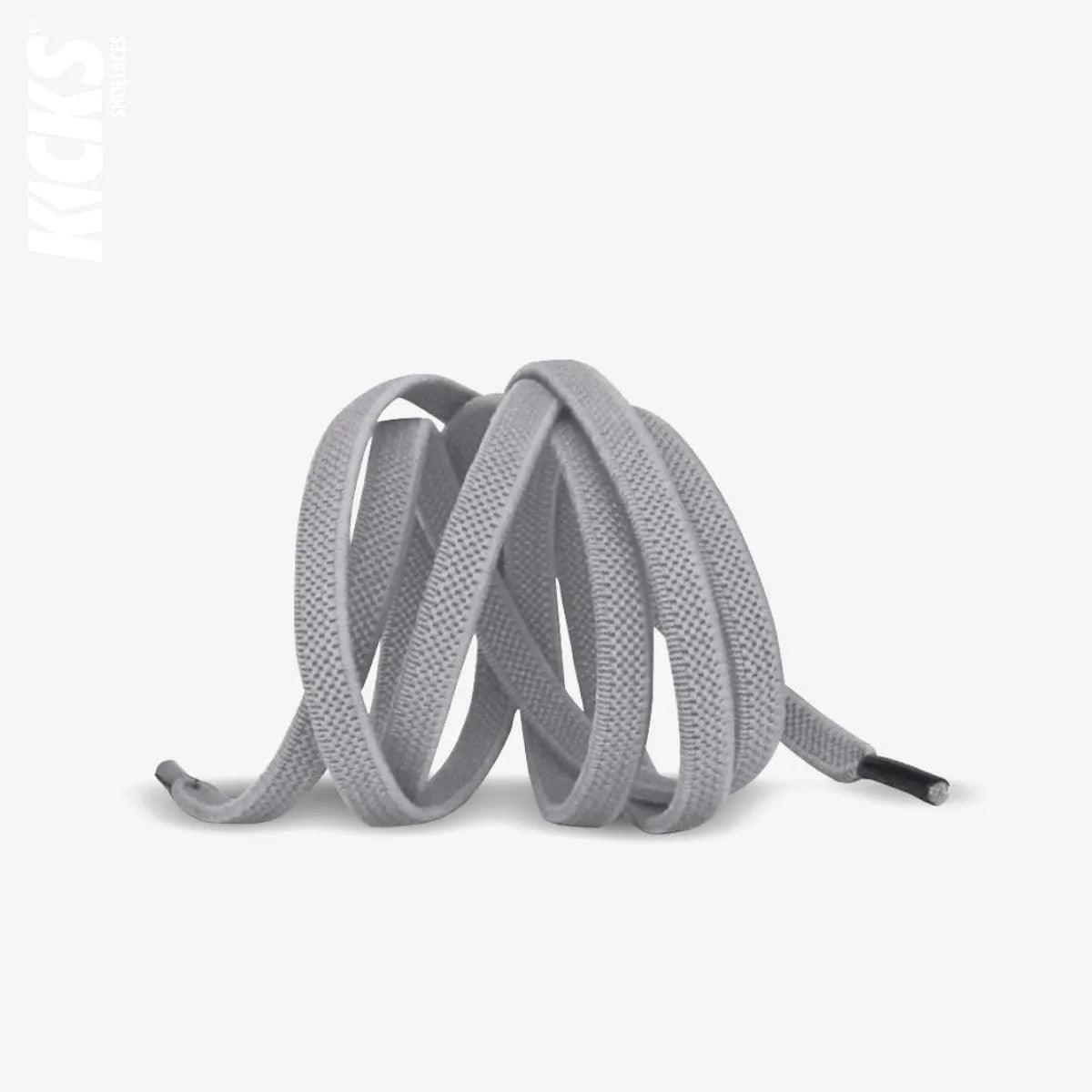 Light grey elastic no-tie shoelaces with a buckle lock system installed on sneakers for a secure slip-on fit without tying the laces, by Kicks Shoelaces.