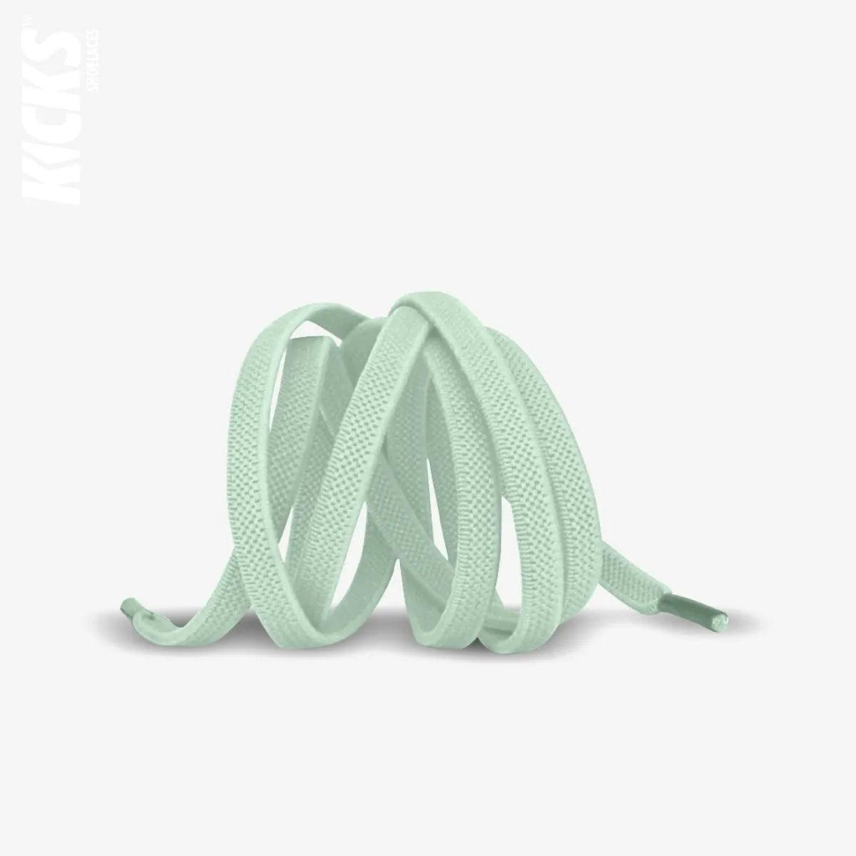 Pastel green elastic no-tie shoelaces with a buckle lock system installed on sneakers for a secure slip-on fit without tying the laces, by Kicks Shoelaces.