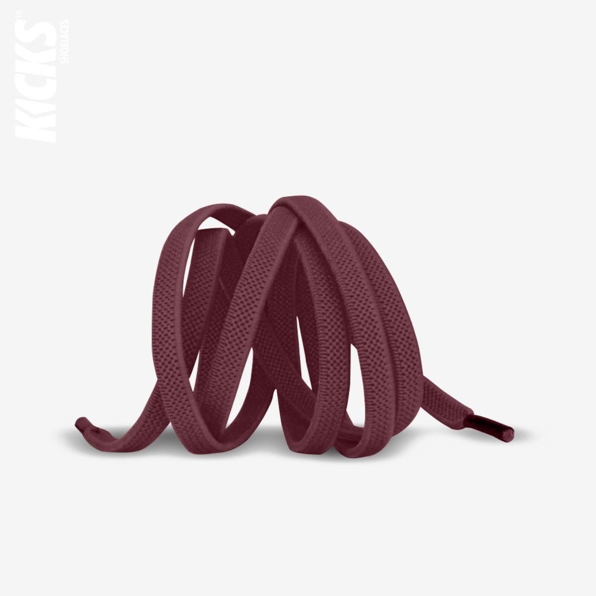 Wine red elastic no-tie shoelaces with a buckle lock system installed on sneakers for a secure slip-on fit without tying the laces, by Kicks Shoelaces.